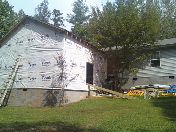 Tyvek wrapped gable on a new room addition beside an existing home in Huntsville